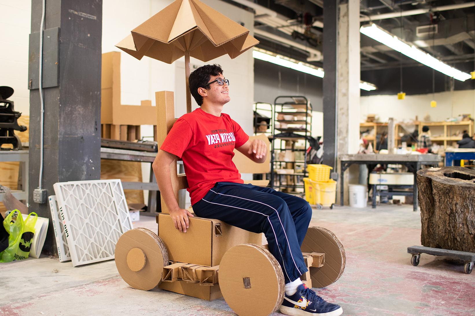 Jeremy Vega poses in cardboard bicycle